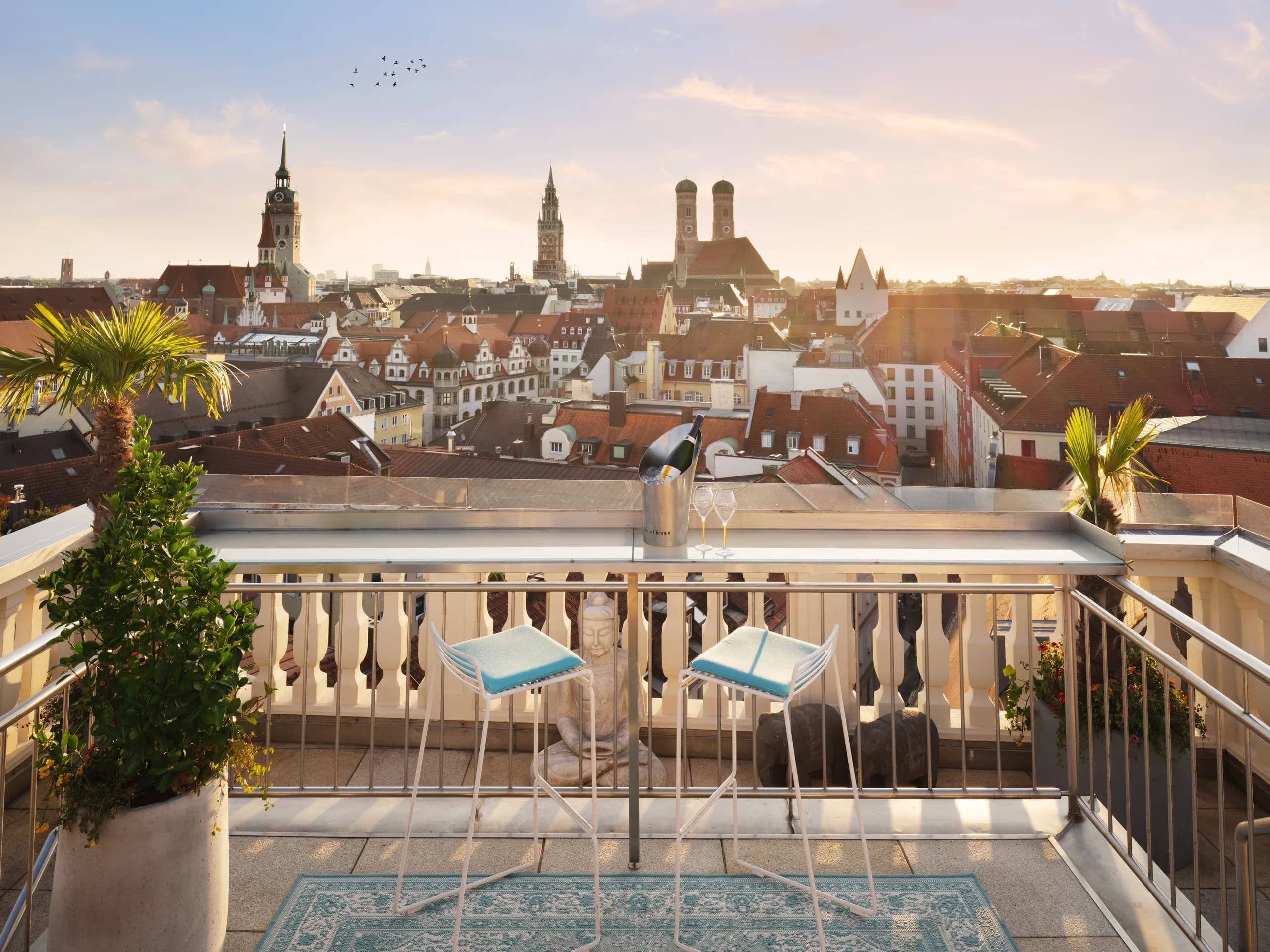 The rooftop terrace at Mandarin Oriental, Munich, looking across the old town at sunset