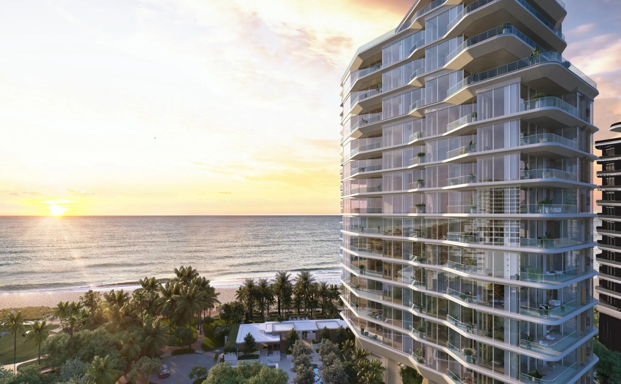 The Aman Residences tower on Miami Beach at sunrise, curved white balconies stacked above the palms with the Atlantic to one side.