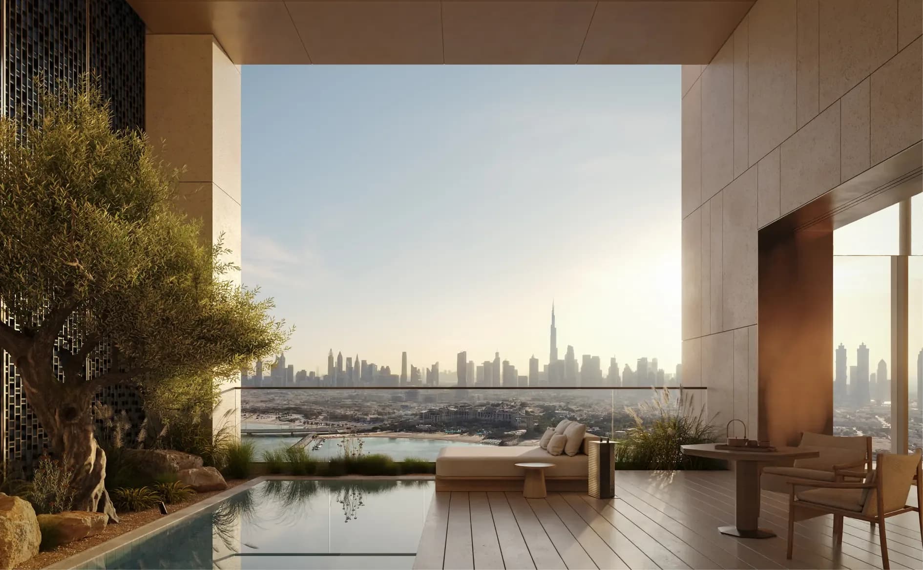 A residence terrace at Aman Residences, Dubai, a plunge pool and day bed under a deep stone portal that frames the city skyline, the Burj Khalifa on the horizon.