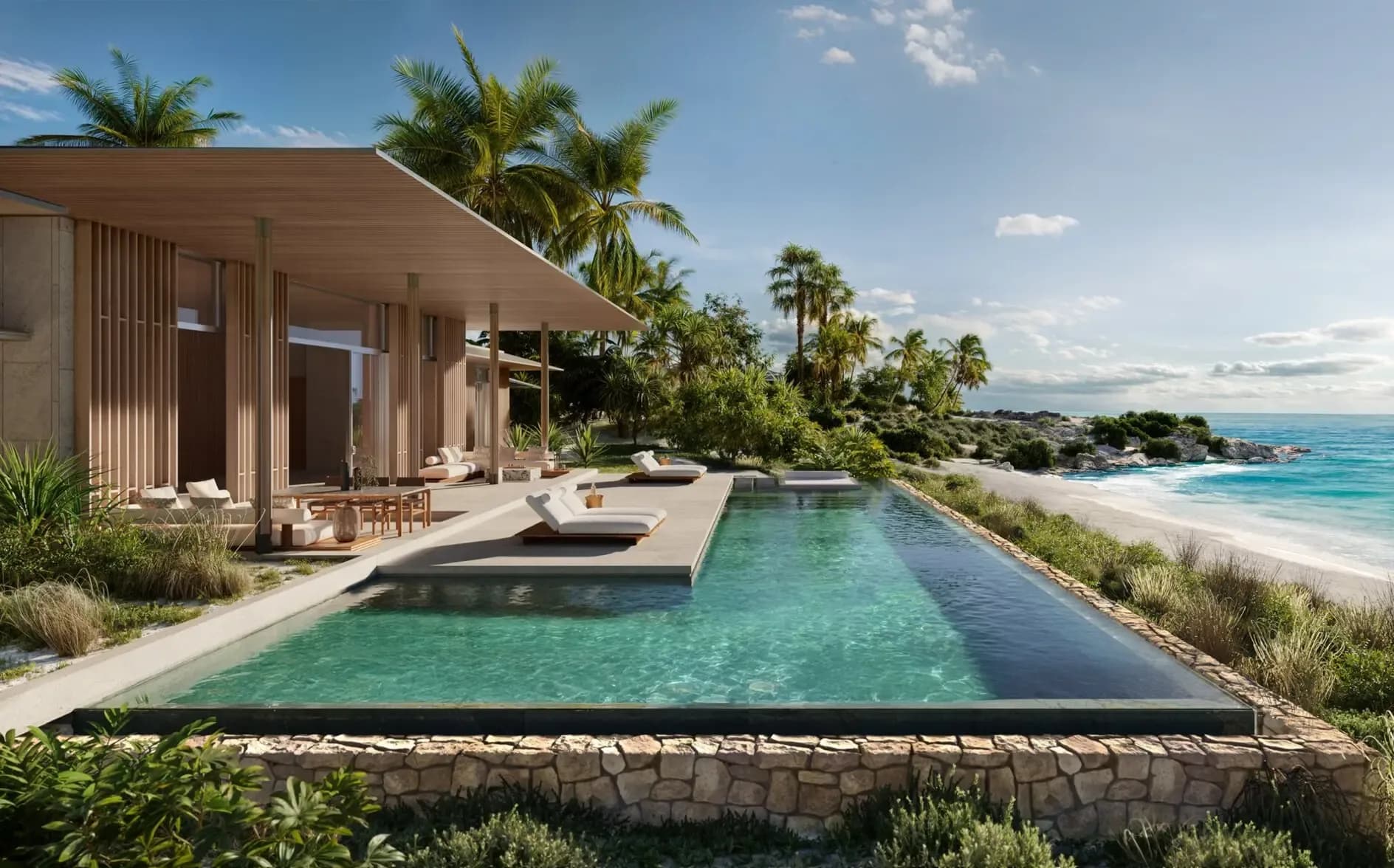 A villa pool terrace at Aman Residences, Amancaya, loungers along a long pool, with planted dunes and the shallows of Exuma beyond.