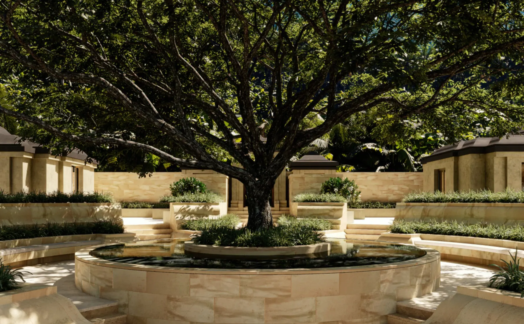 The central courtyard of an Amanjiwo residence, a circular water basin set around a mature tree with low stone pavilions on every side.