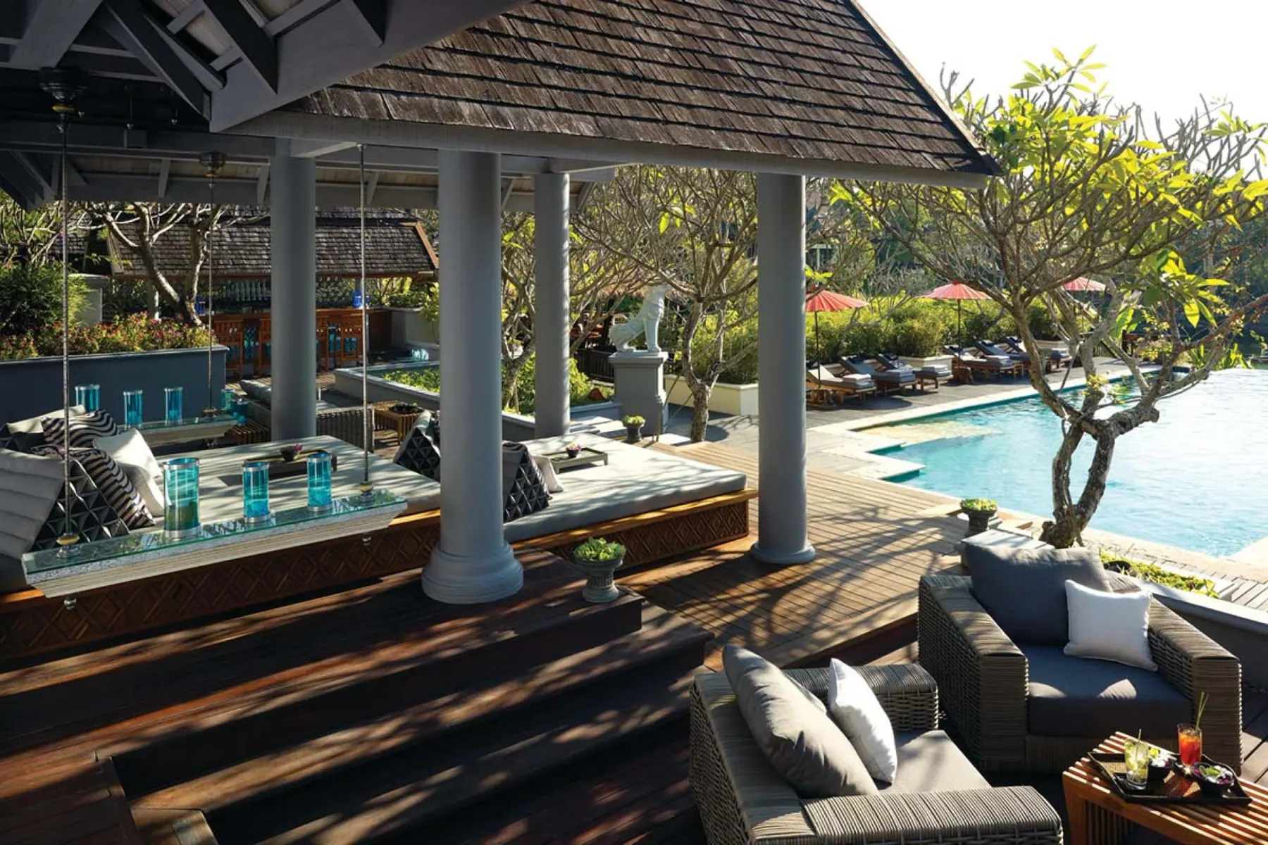 A shaded sala and pool terrace at the Residences at Four Seasons Resort Chiang Mai.