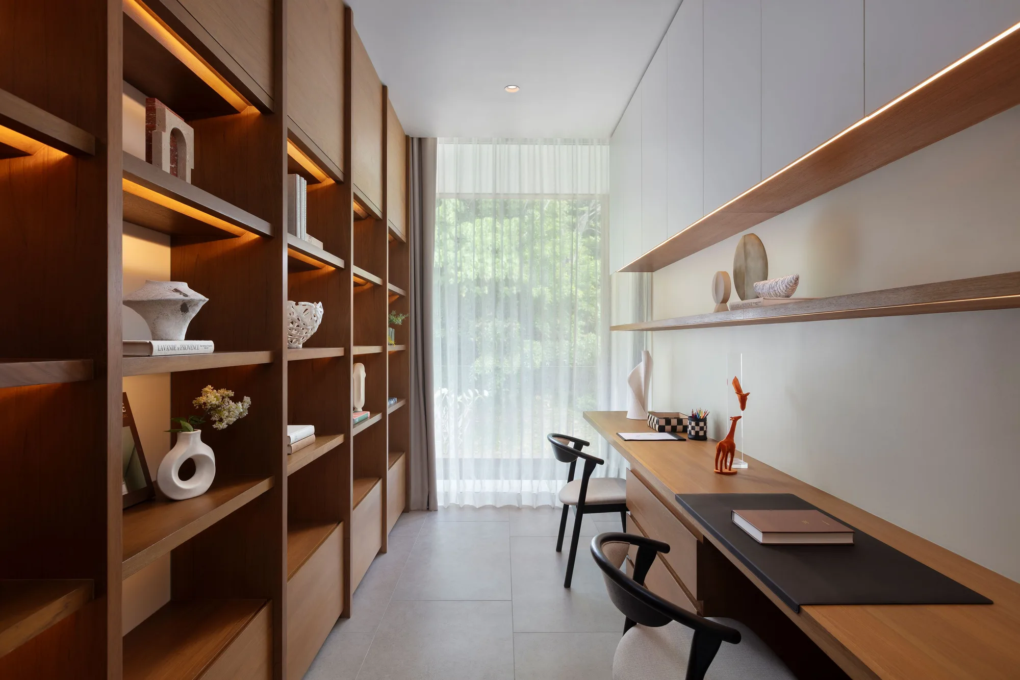 Study with lit timber shelving and a long desk under a curtained window