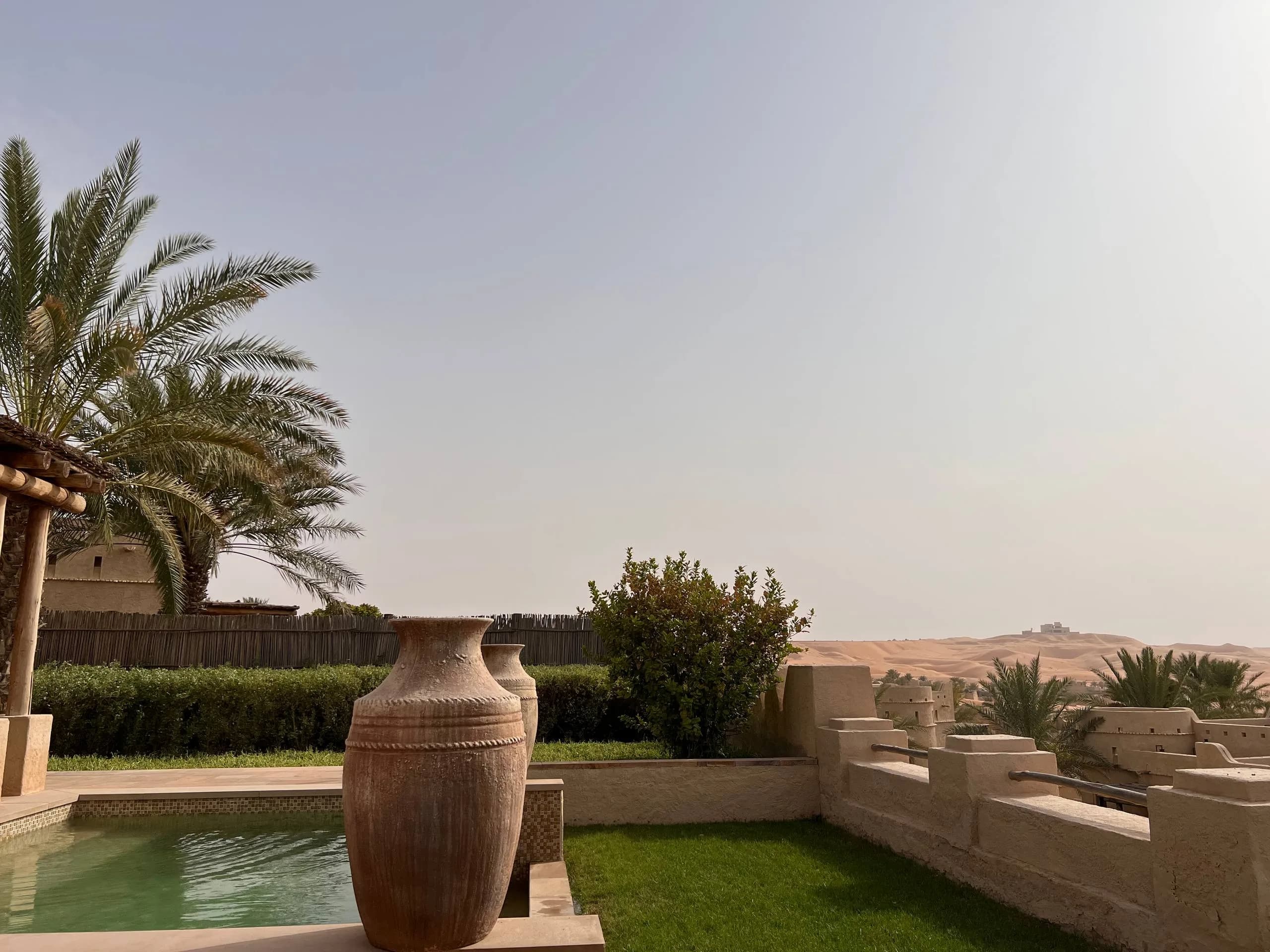 Private plunge pool and garden of a One Bedroom Anantara Pool Villa at Qasr Al Sarab, with the Liwa Desert dunes beyond