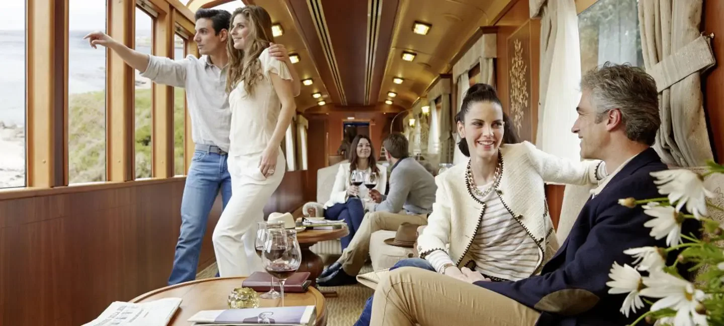 A lounge car with the coast outside