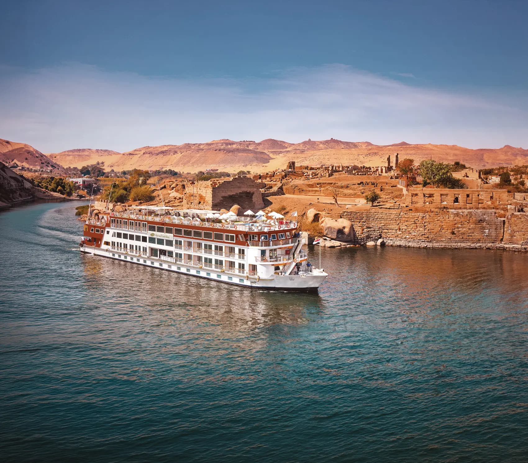 AmaDahlia on the Nile passing temple ruins and desert hills