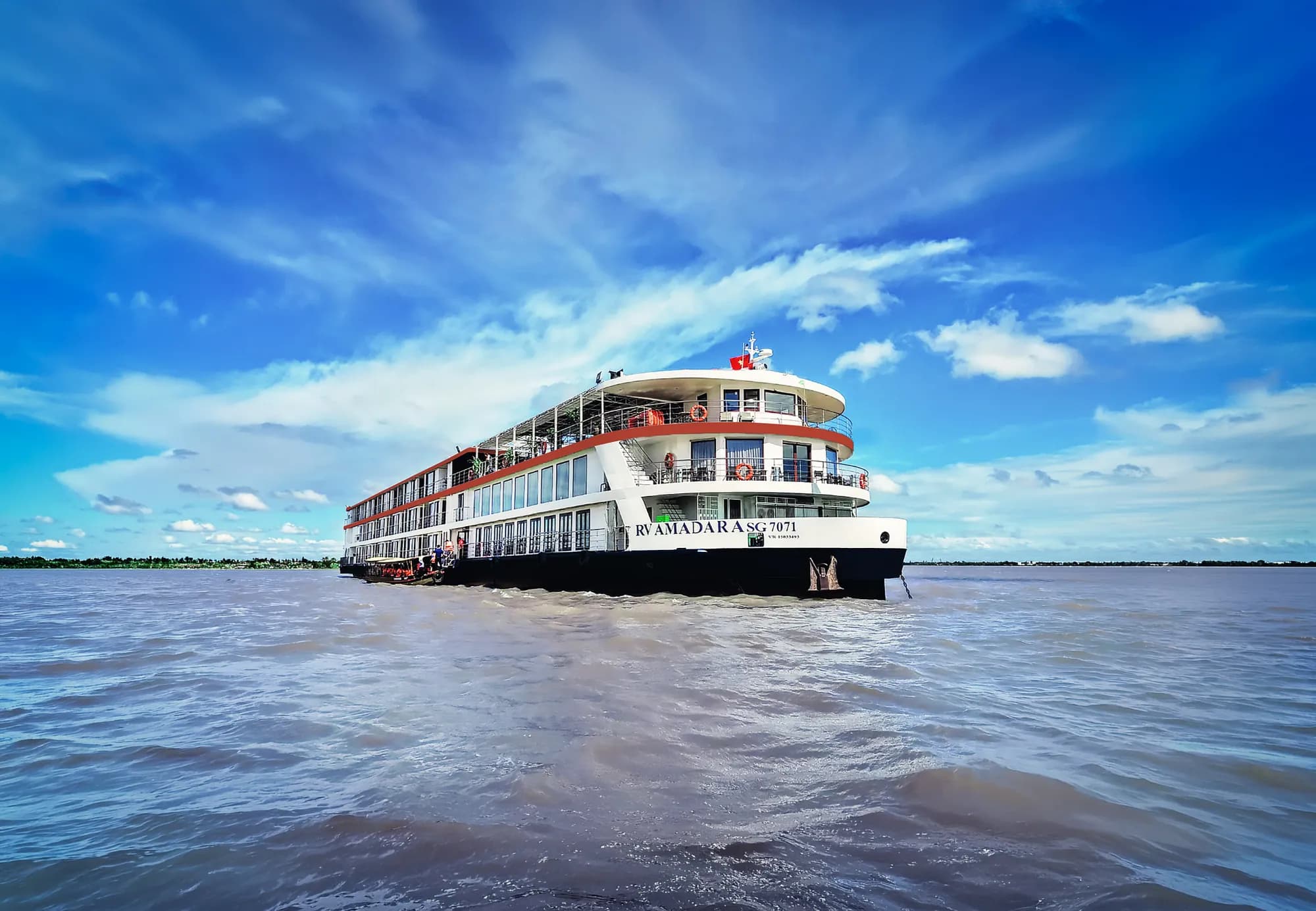 AmaDara at anchor on the wide brown Mekong under a blue sky