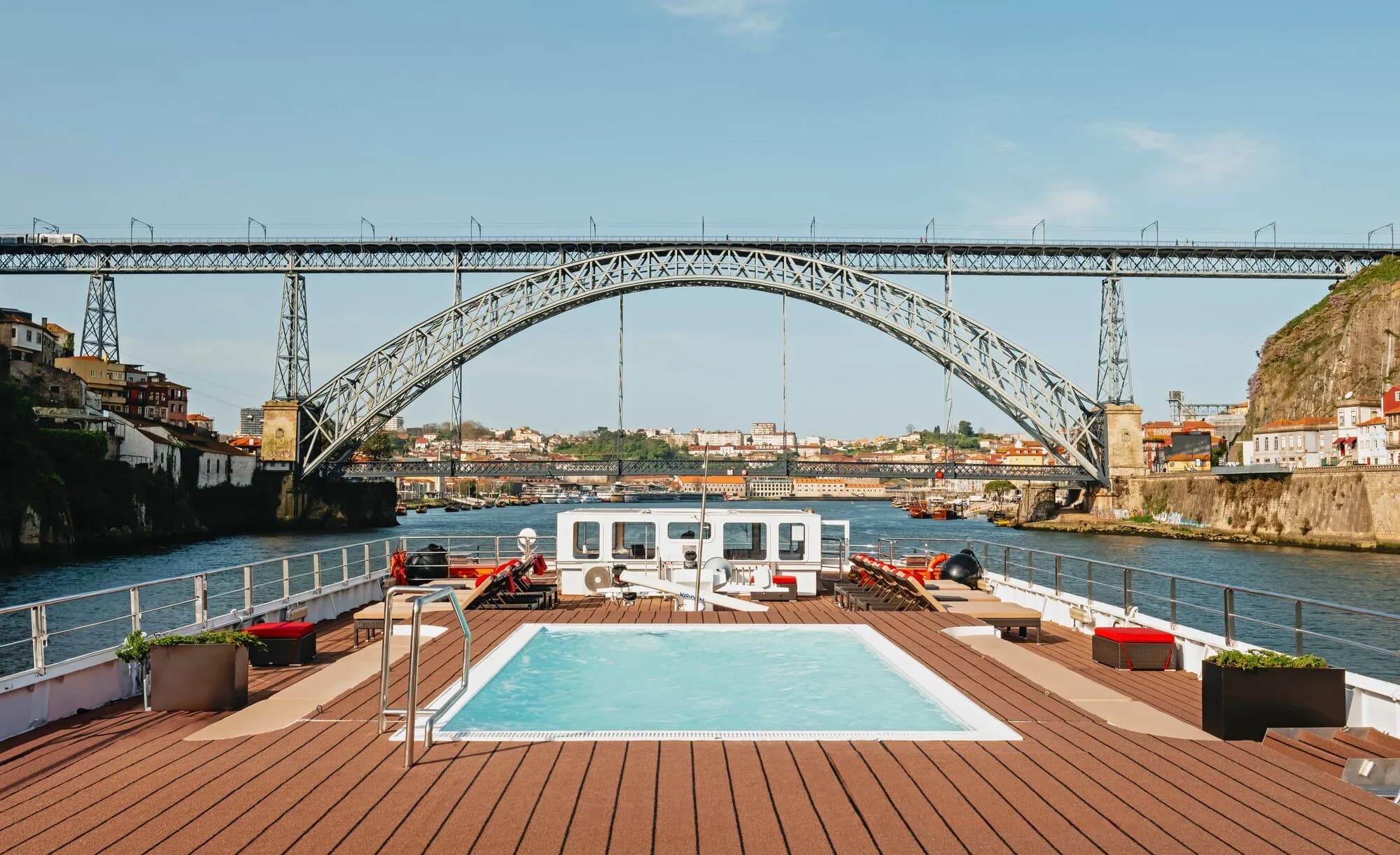 The sun deck pool on AmaVida facing the iron arch of the Dom Luís I bridge in Porto