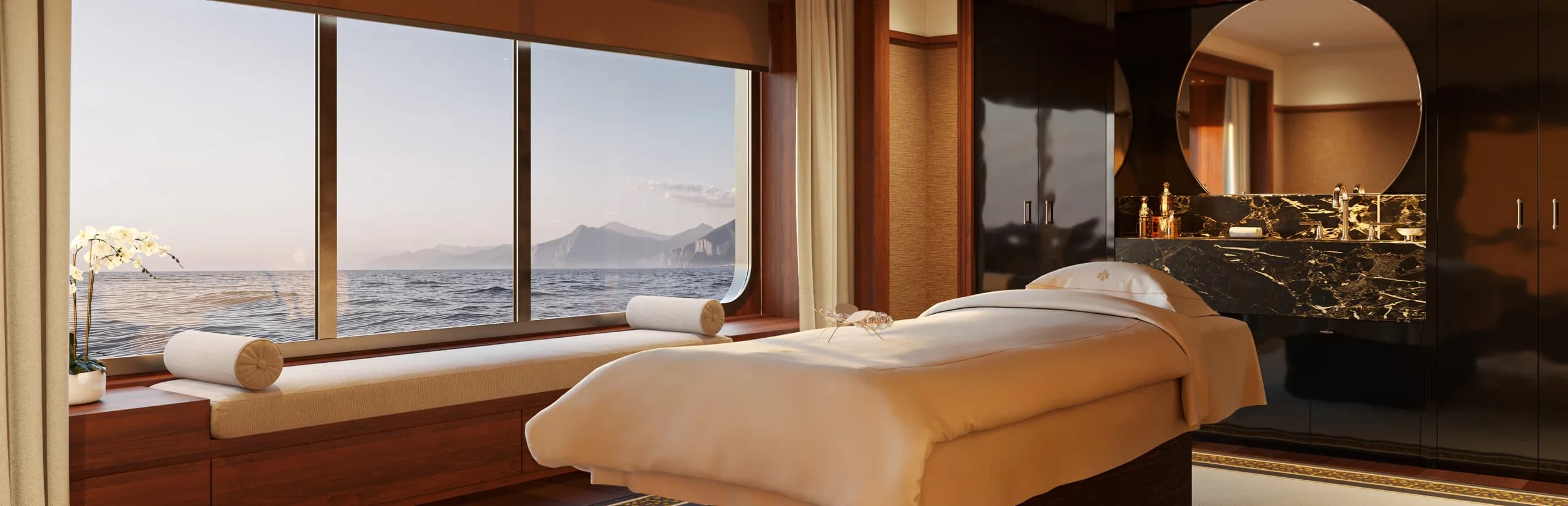 A Guerlain Spa treatment room aboard Corinthian, its picture window over the sea