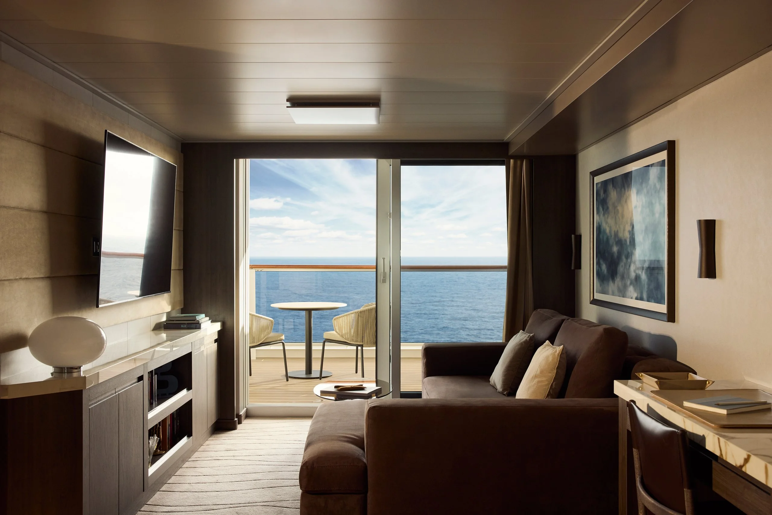 A Cove Residence aboard Explora I — living area opening to a private terrace over the ocean