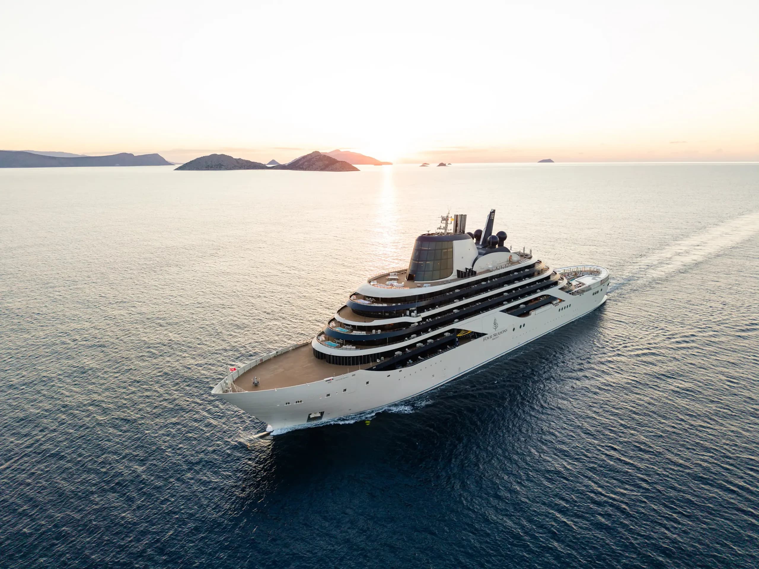 Four Seasons I under way at sunset, a yacht of 95 suites