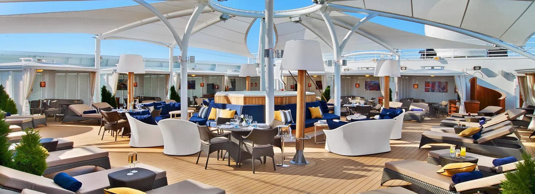 The Retreat on Seabourn Encore, cabanas, loungers and a whirlpool under a white sail canopy on the top deck