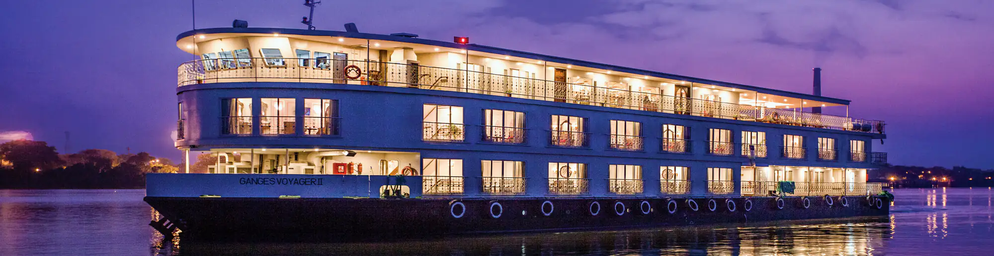 Ganges Voyager II lit up on the river at dusk