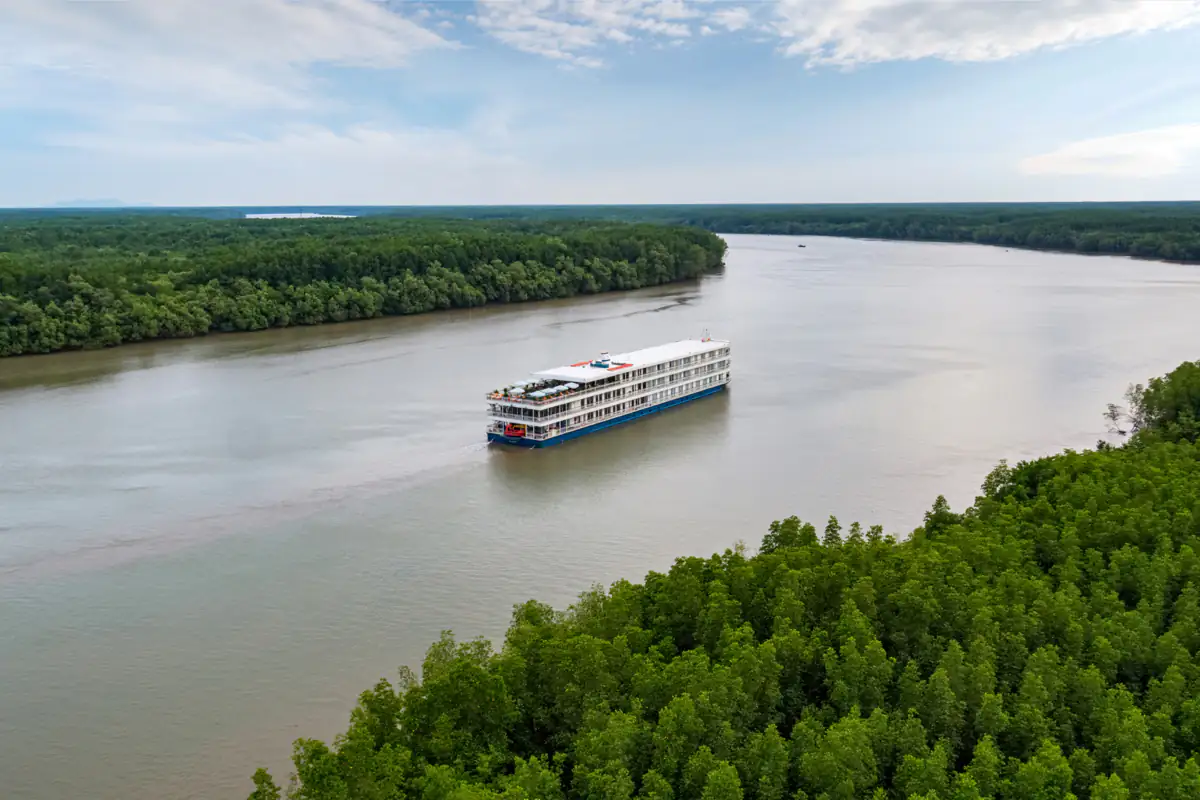 Mekong Jewel on a wide brown river between mangrove forest, seen from above