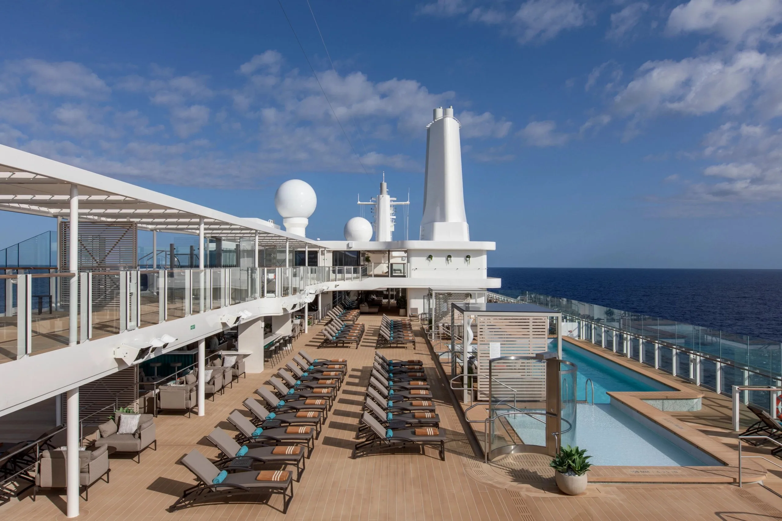 The pool deck aboard Silver Nova, with the pool set against the ship's rail