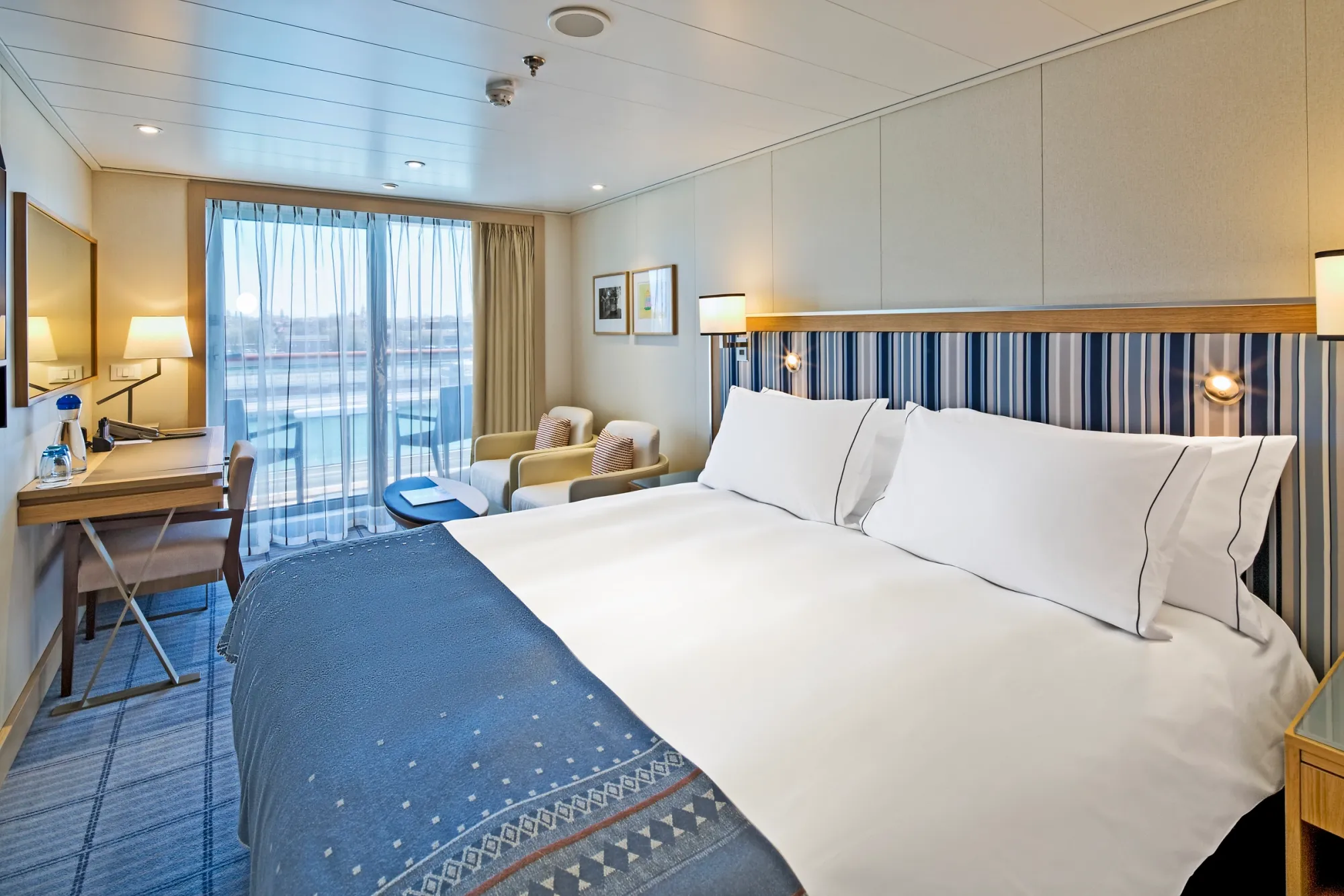 A veranda stateroom on Viking Star, a king bed facing a sliding glass door to the veranda
