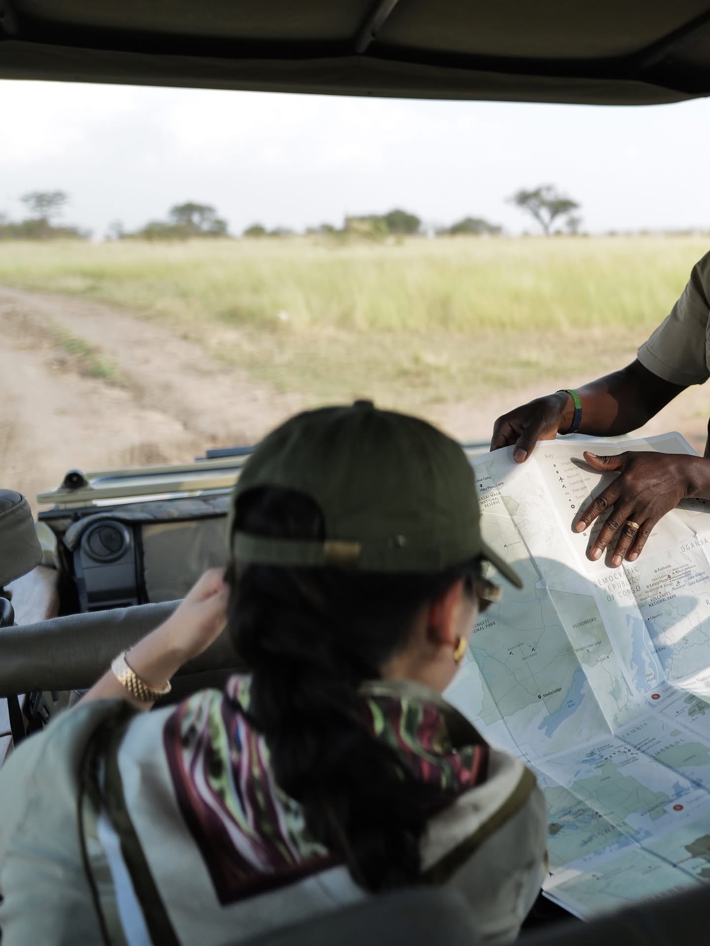 Safari guide pointing at map