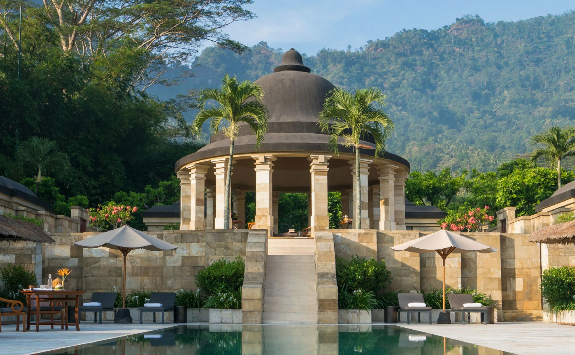 The domed rotunda of Amanjiwo above its pool, with the Menoreh Hills behind
